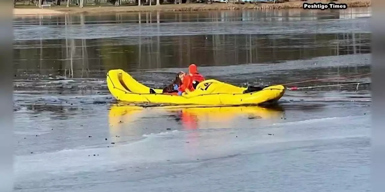 Firefighters use inflatable boat to rescue dog that fell through thin ice