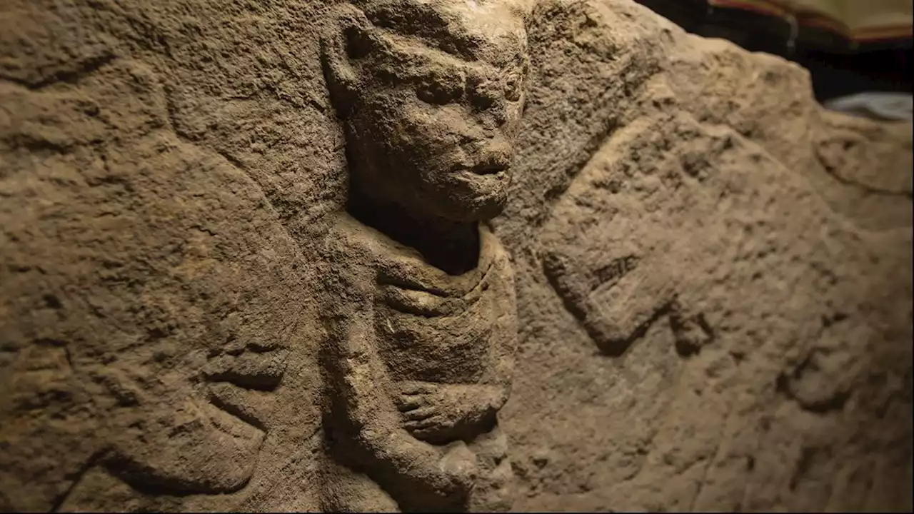 Man holding penis and flanked by leopards is world's oldest narrative carving