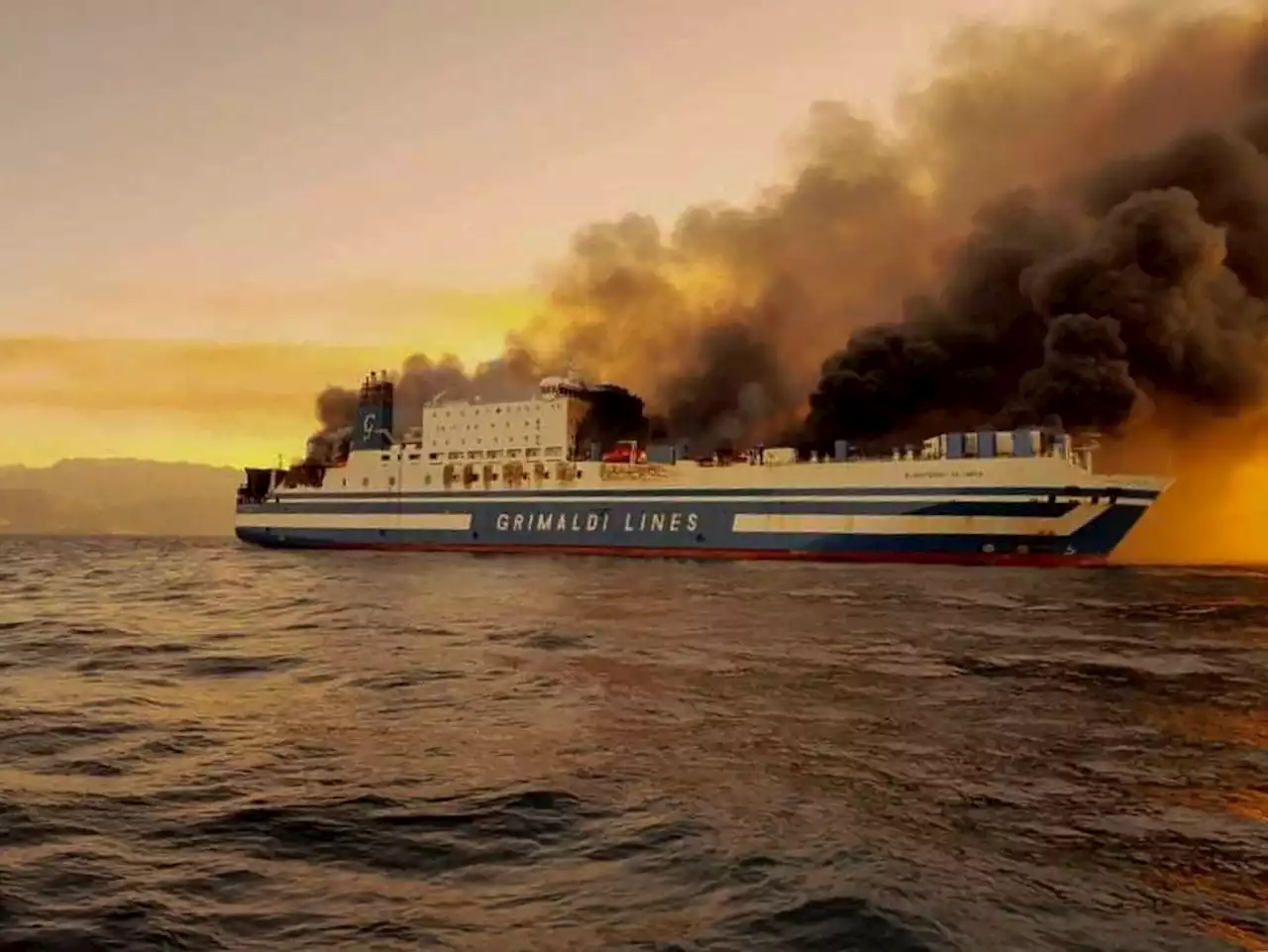 Greek rescuers search burning ferry for 12 missing people