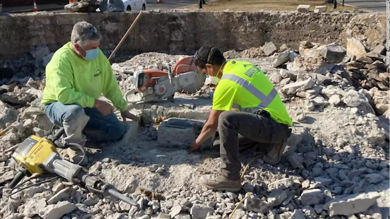 Workers find a box under a Jefferson Davis Confederate monument. The Black History Museum will decide its future