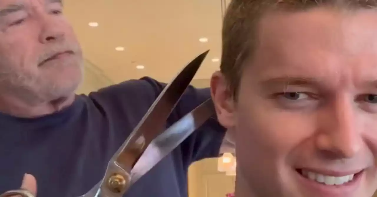 Watch Arnold Schwarzenegger cut son Patrick's hair with giant scissors