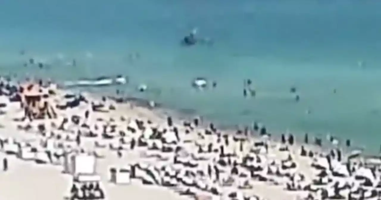 Heart-stopping moment chopper plunges into ocean off beach filled with swimmers