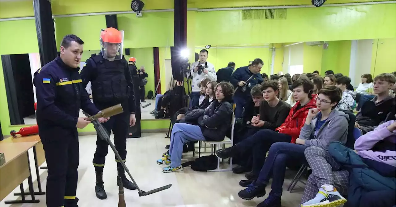 Students try bulletproof vests and escape drills in east Ukraine