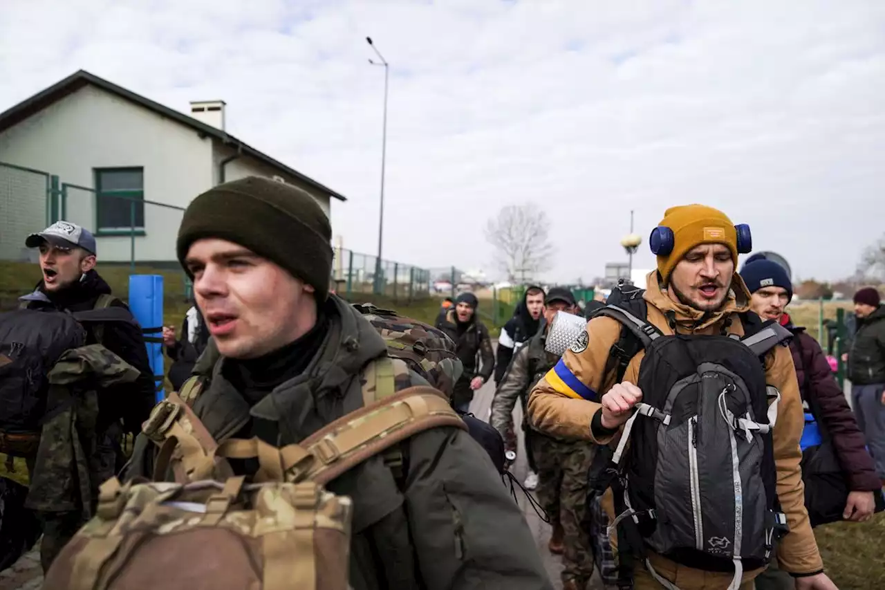 As refugees flee to Poland, Ukrainians from around the world return home to fight