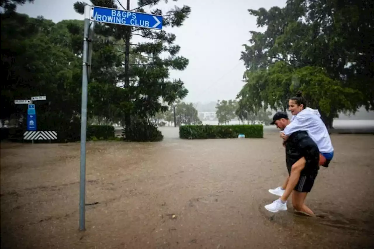 Rooftop rescues in Australia as tens of thousands evacuated from floods