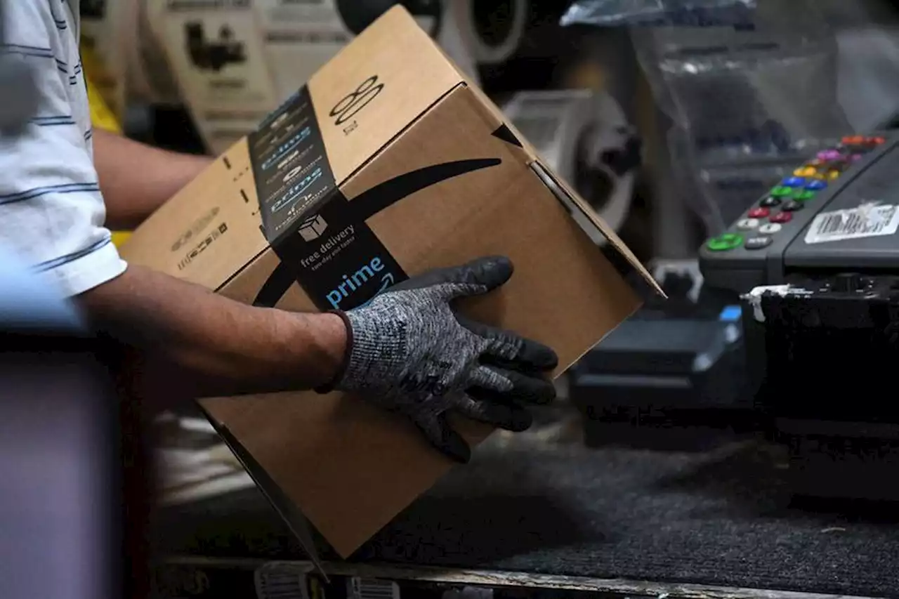Amazon surges, eyes Wall Street record gain in value