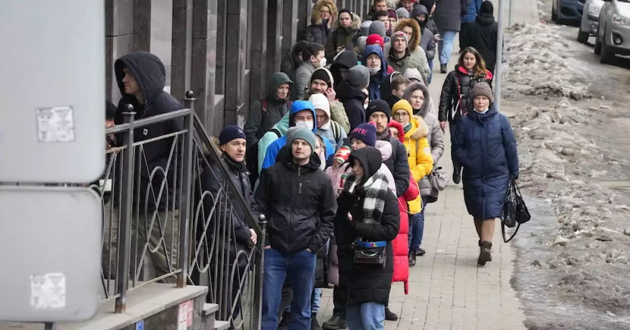 Russians line up at banks, ATMs as ruble crashes amid sanctions