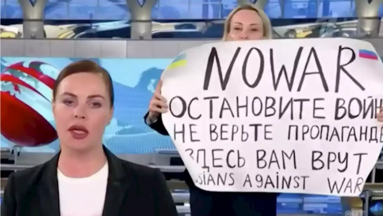 Russian TV protester tells of 14-hour interrogation, may still face prison term