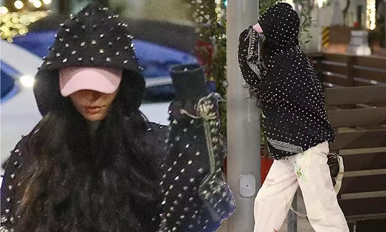 Megan Fox looks edgy in a black studded hoodie while running errands