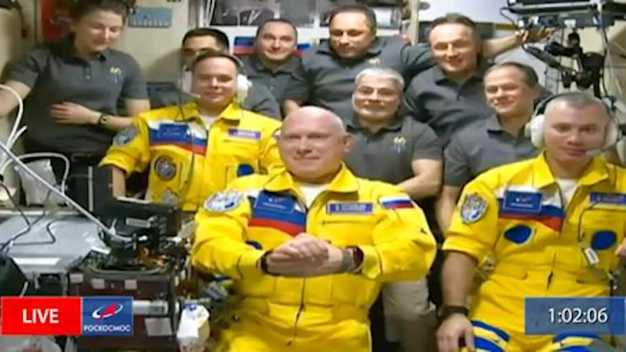 Russian cosmonauts in yellow-blue suits arrive at ISS