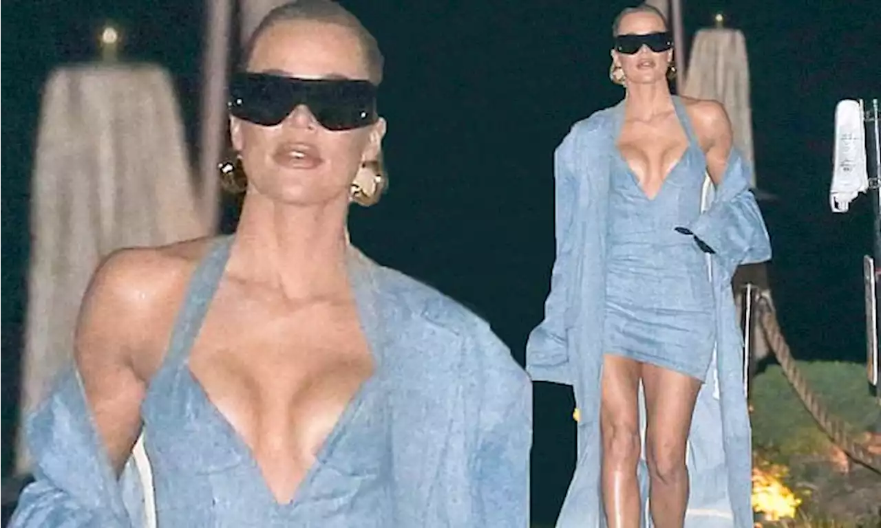 Khloe Kardashian showcases her figure in plunging denim mini dress