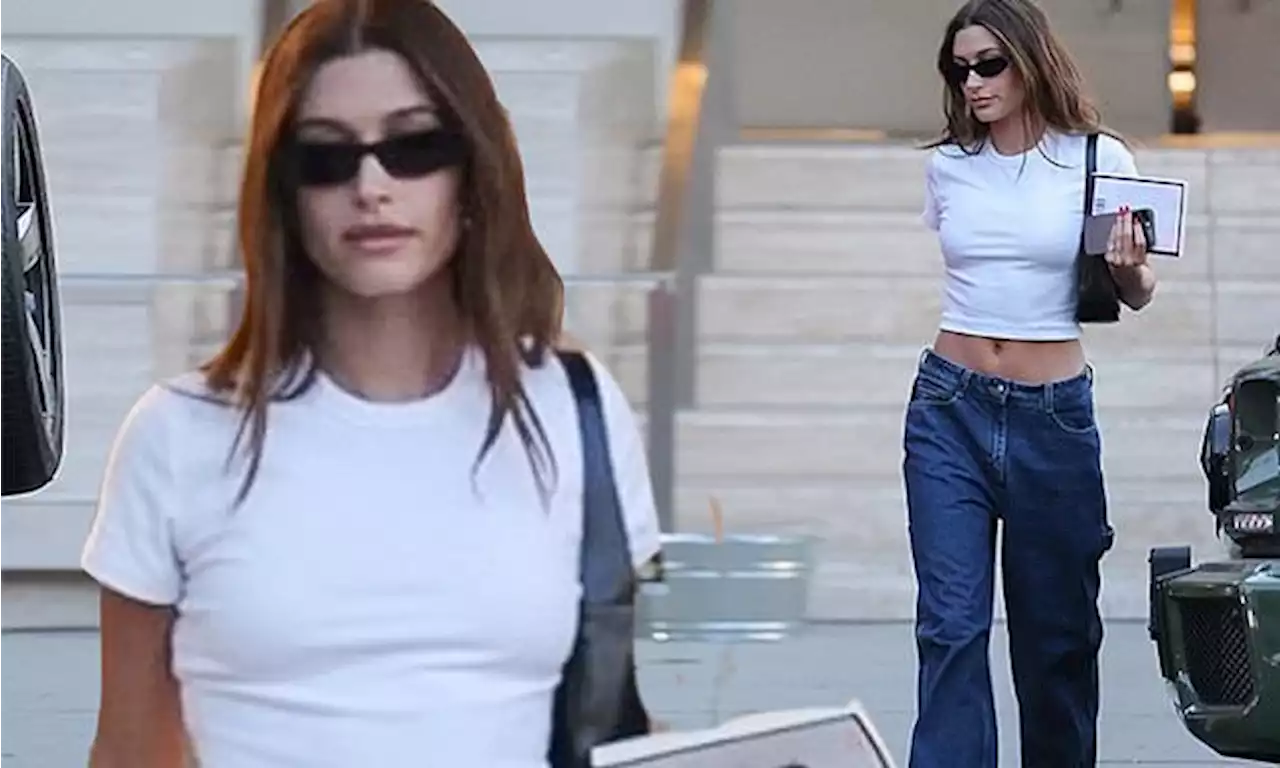 Hailey Bieber showcases her flat midriff in low-slung jeans in LA