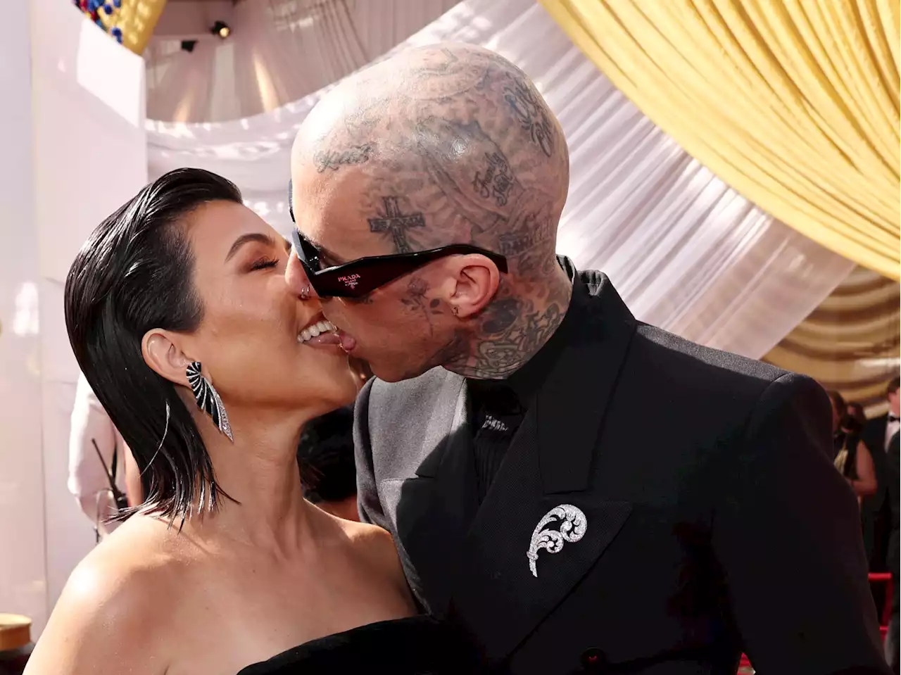 Kourtney Kardashian and Travis Barker kiss on the Oscars red carpet