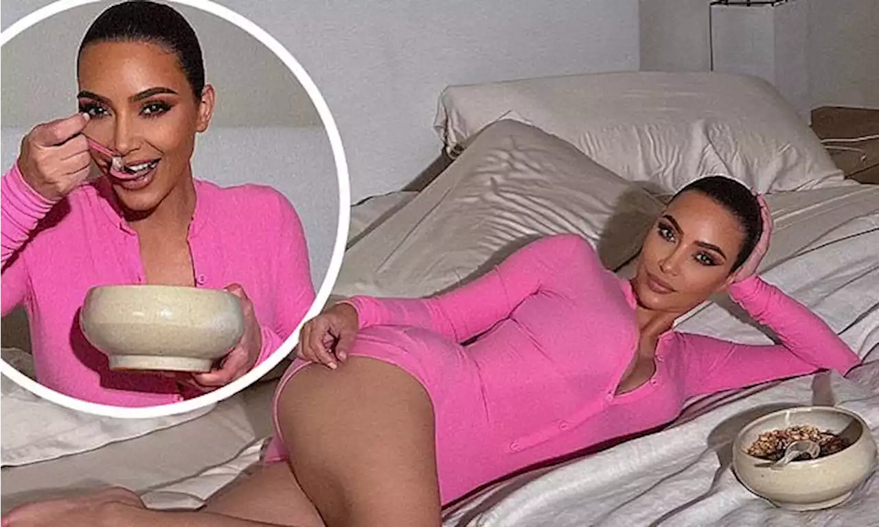 Kim Kardashian chows down on a bowl of cereal and snaps selfies in bed