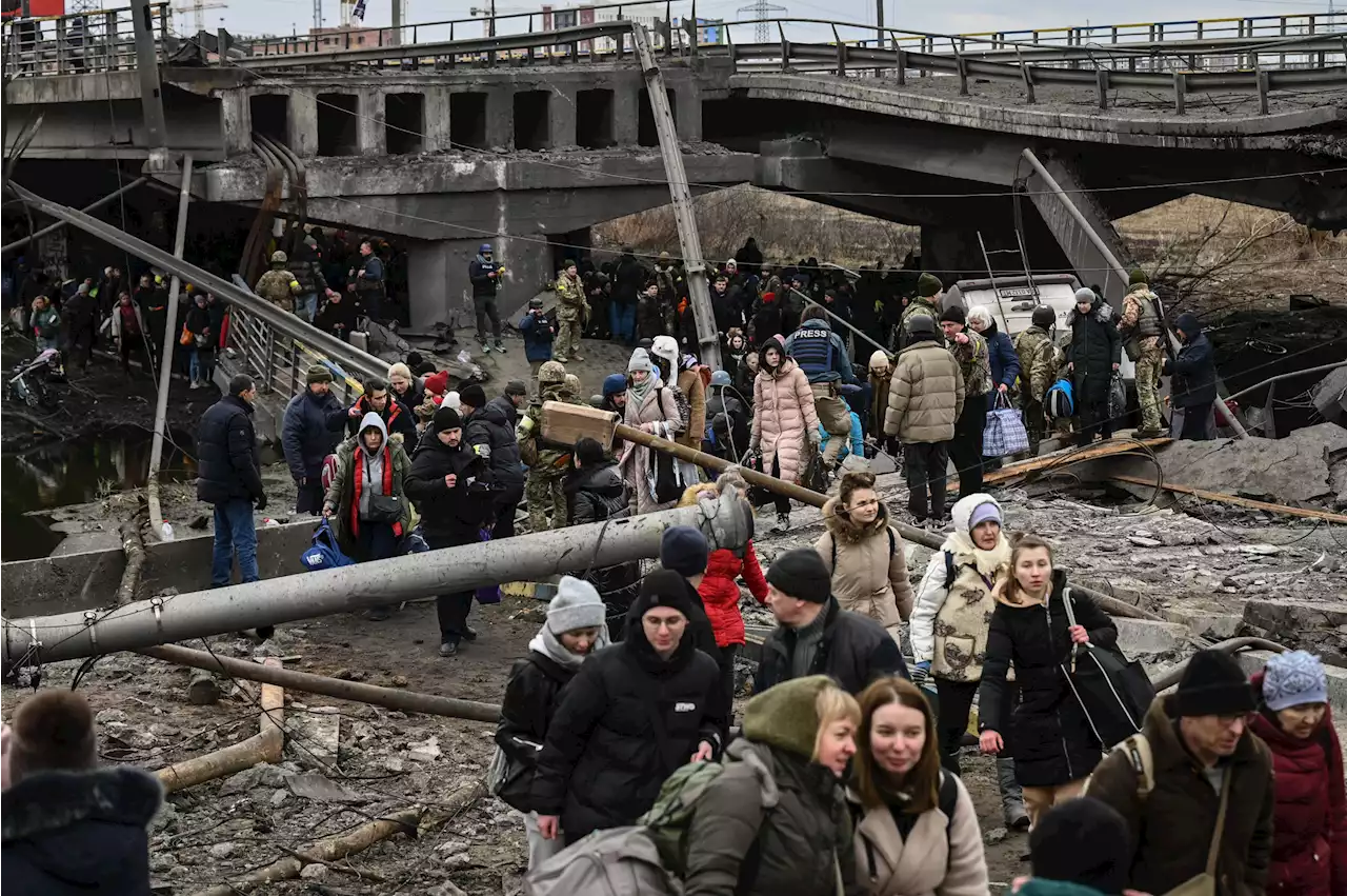 Zelensky says airport outside Kyiv destroyed as 1.5 million people flee Ukraine