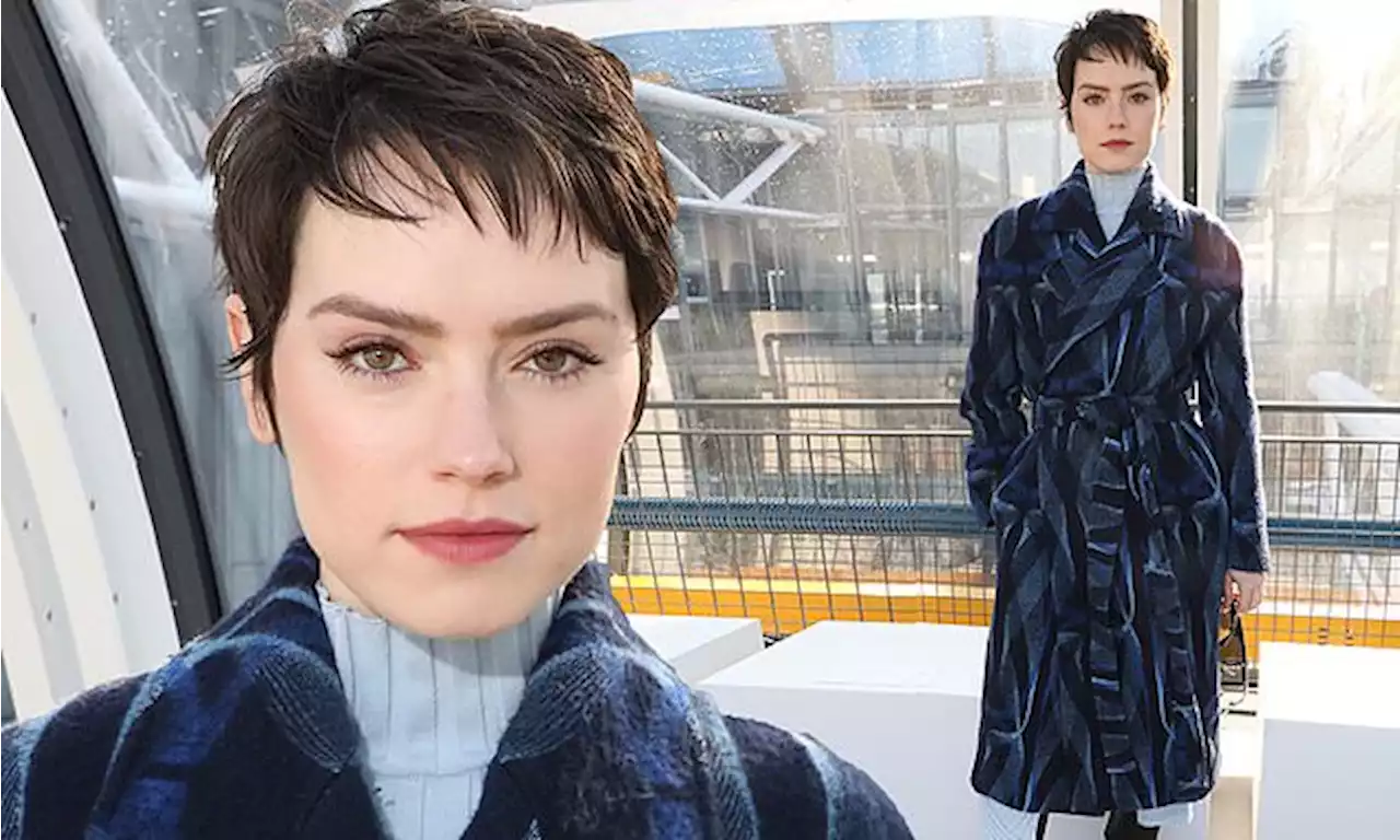 Daisy Ridley looks chic in a belted blue coat at Paris Fashion Week