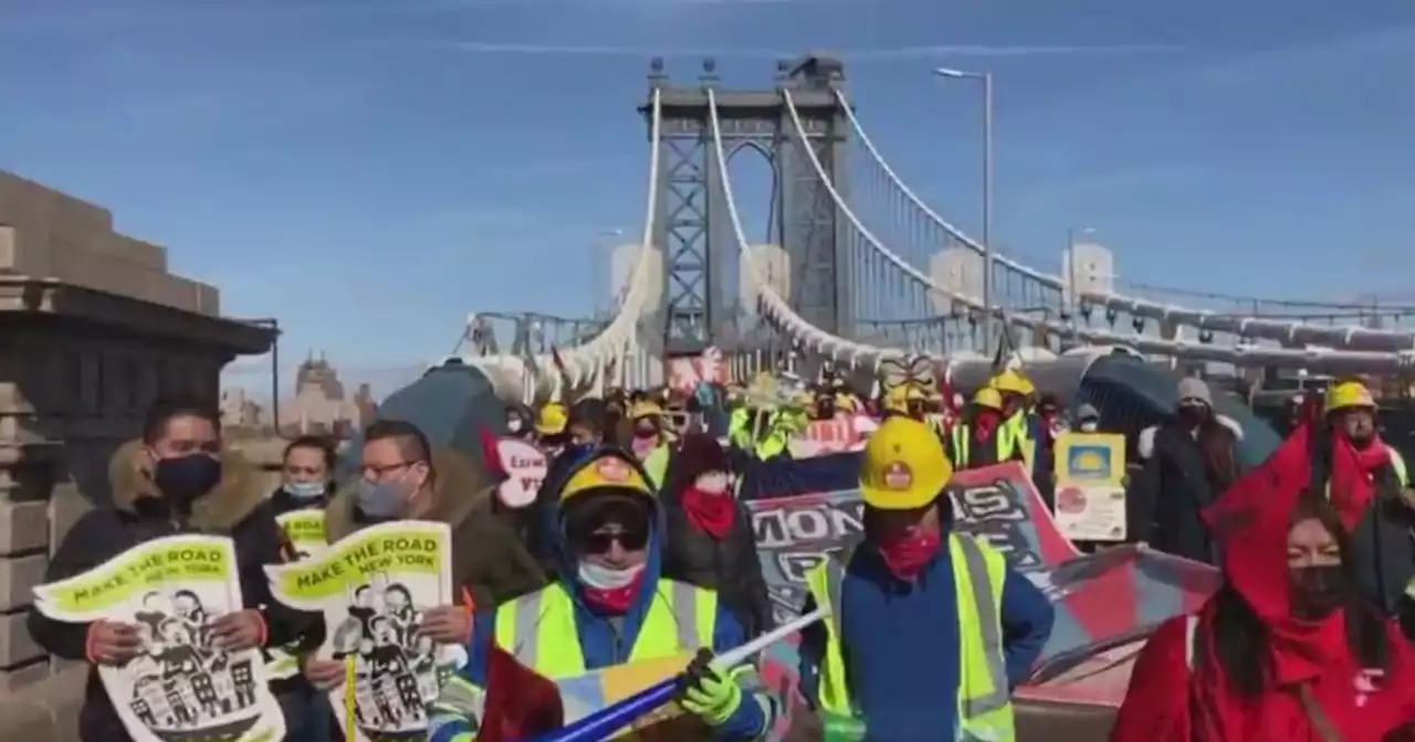 Protesters march across Brooklyn Bridge calling for more pandemic relief for excluded workers