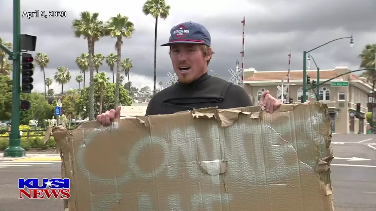 San Diego surfer protests countywide beach closures with 'Commies Can't Surf' sign -