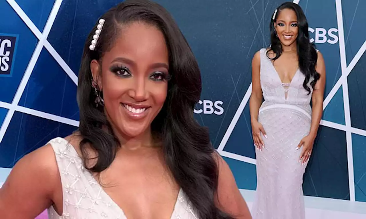 Mickey Guyton cuts an elegant figure in a white gown at the CMTs