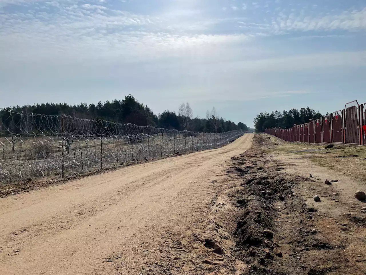 Poland builds a border wall, even as it welcomes Ukrainian refugees