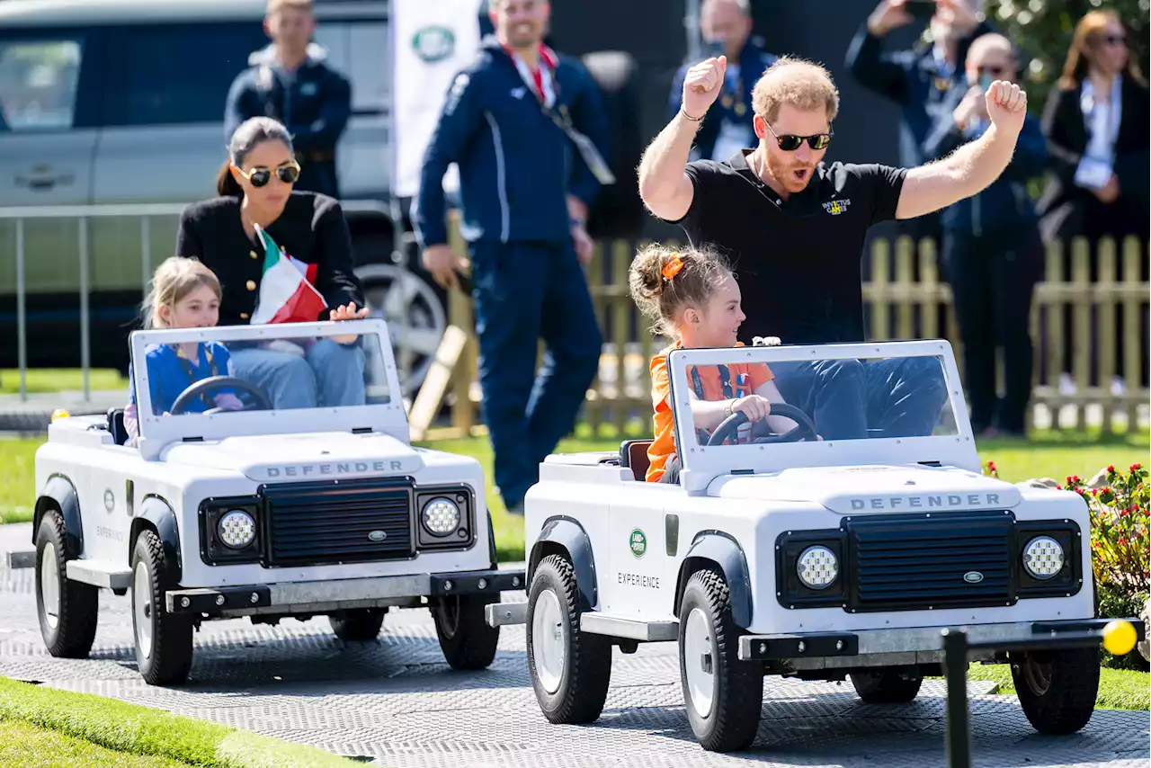 Prince Harry and Meghan Markle ride shotgun in kiddie cars during Invictus Games