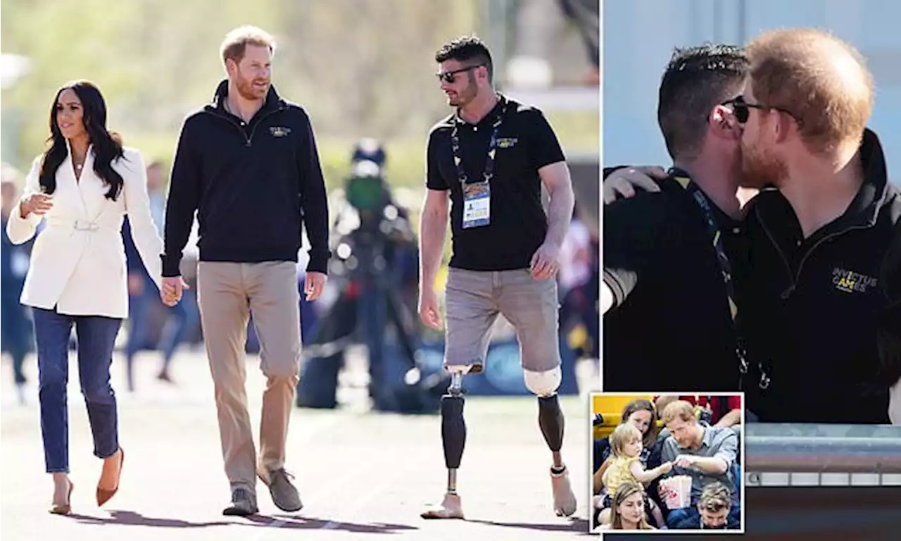 Prince Harry embraces Paralympian Dave Henson at Invictus Games