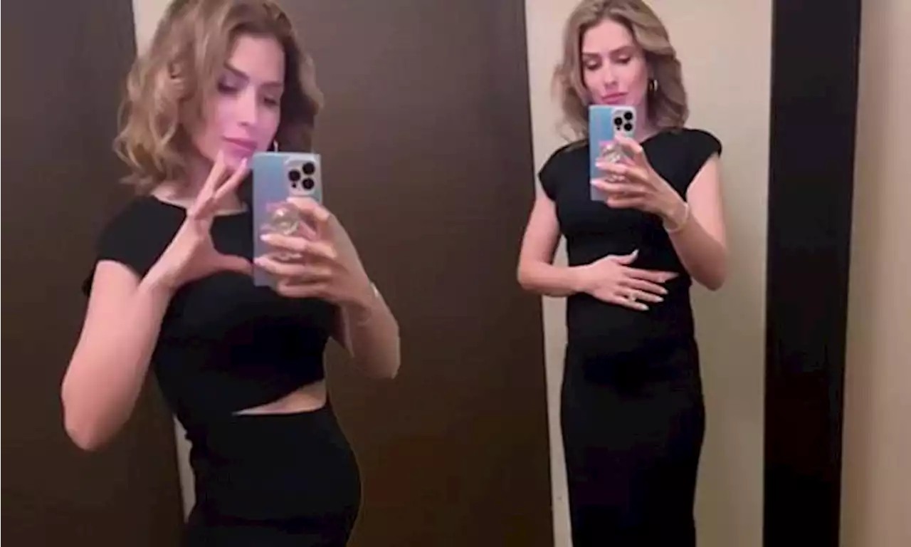 Hilaria Baldwin gives glimpse at growing baby bump in a cut-out dress