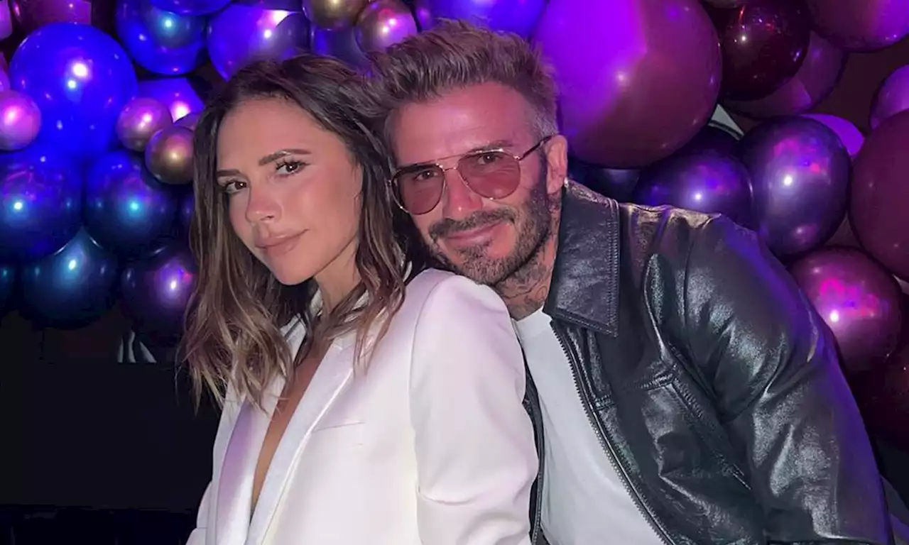 Victoria Beckham flashes a smile as cosies up to husband David Beckham in new photo