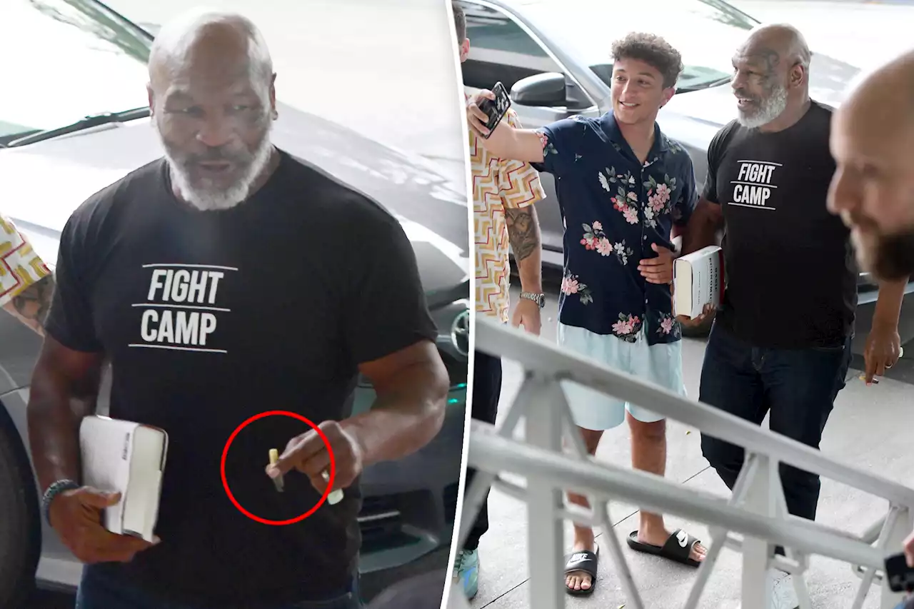 Mike Tyson smoking and smiling in Miami after plane punching incident