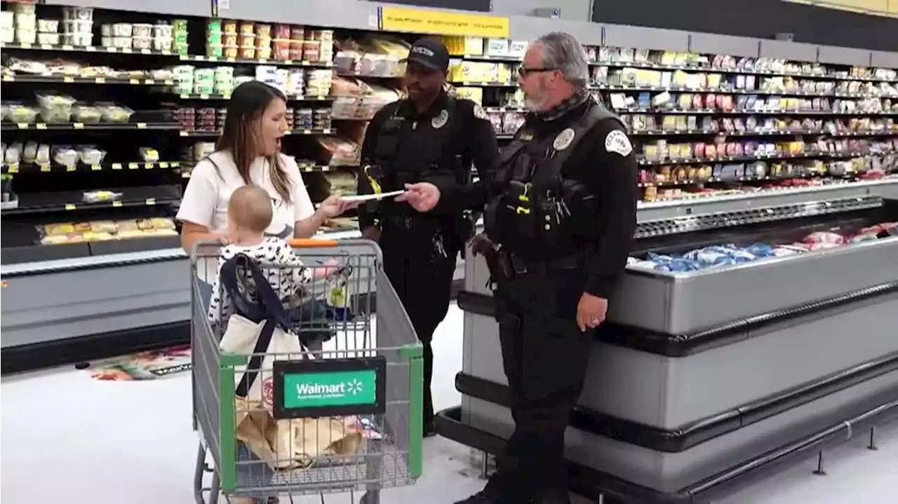 Police officers surprise shoppers with cash in California