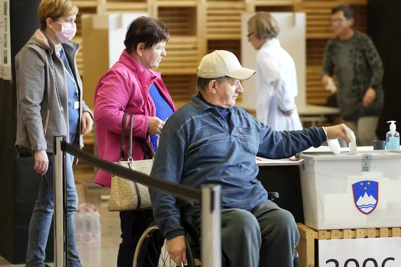 Slovenians vote in tight race between populists, liberals