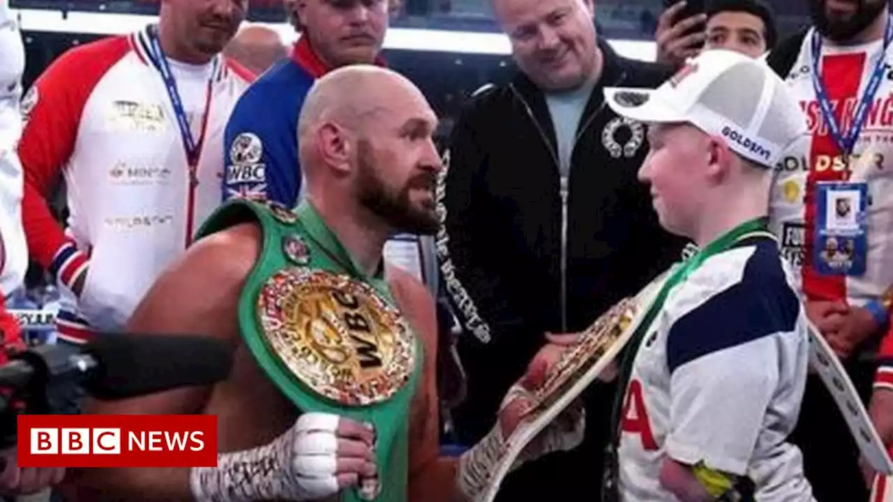 Tyson Fury hugs young fan Marshall Janson in Wembley ring