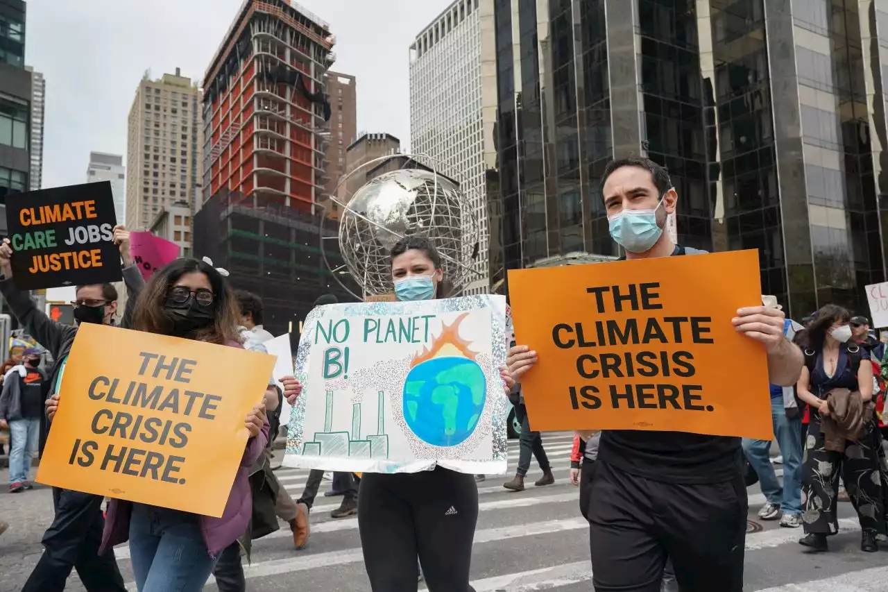 NYC climate protesters block intersection, climb on top of subway station