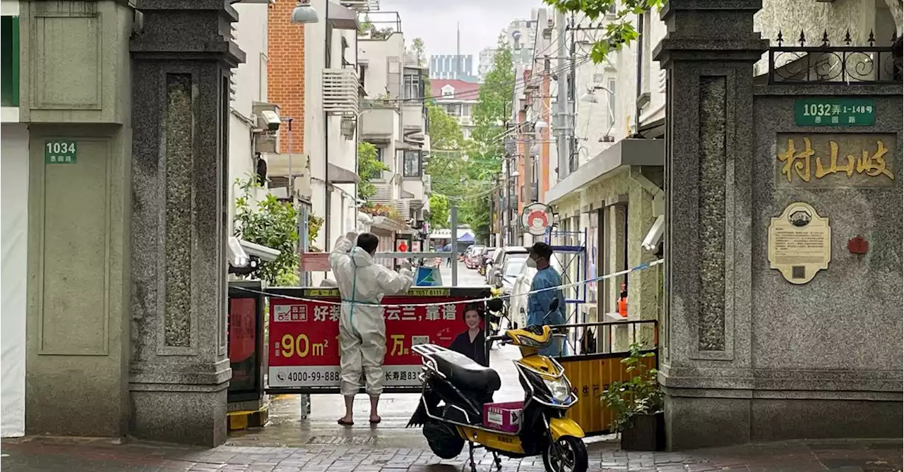 Shanghai fences up COVID-hit buildings, fuelling fresh outcry