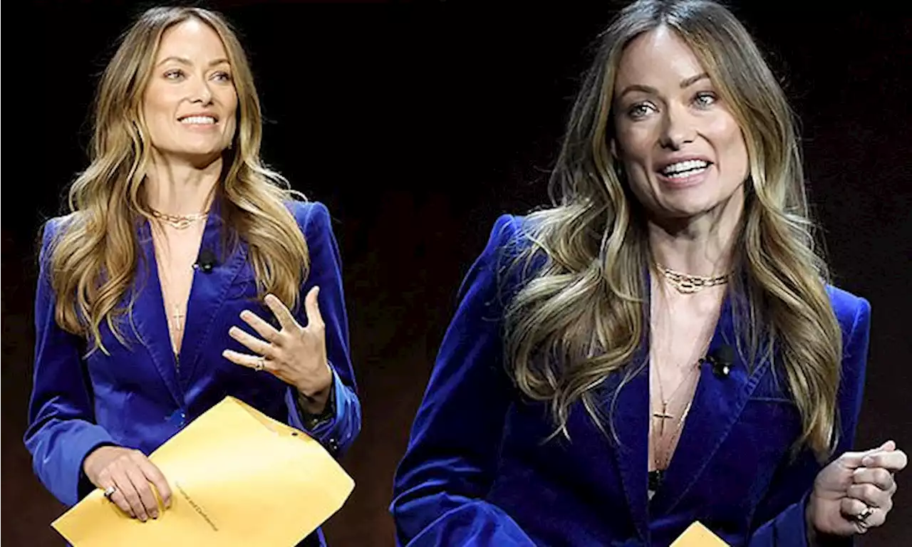 Olivia Wilde gets handed a private and confidential envelope on stage