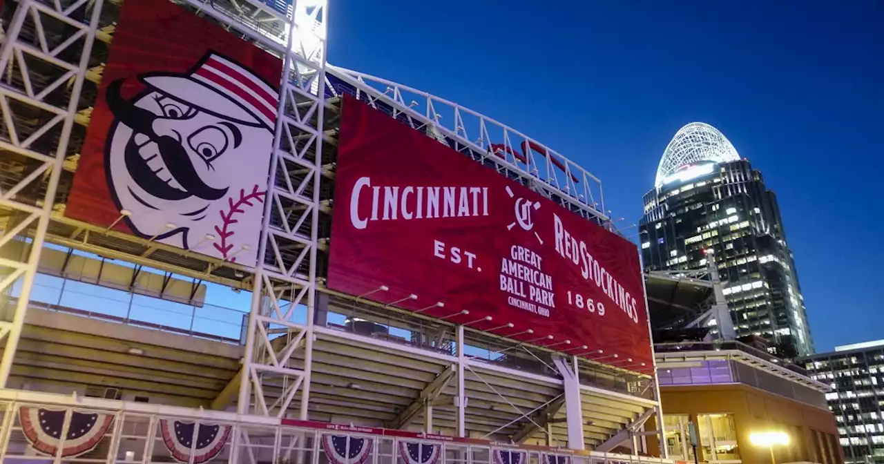 Reds fan catches foul ball with one hand while bottle-feeding baby