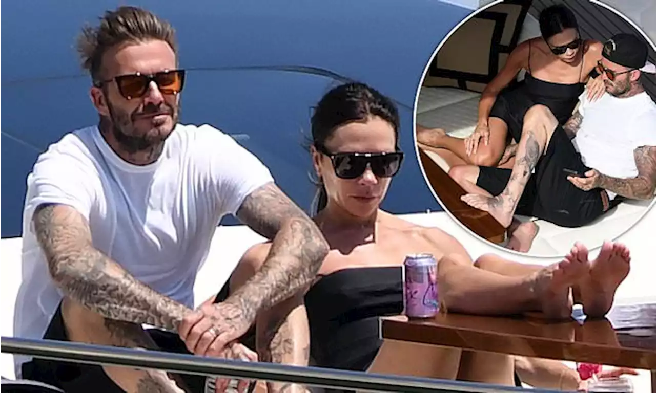 David Beckham cosies up to wife Victoria as they lounge on £5m yacht