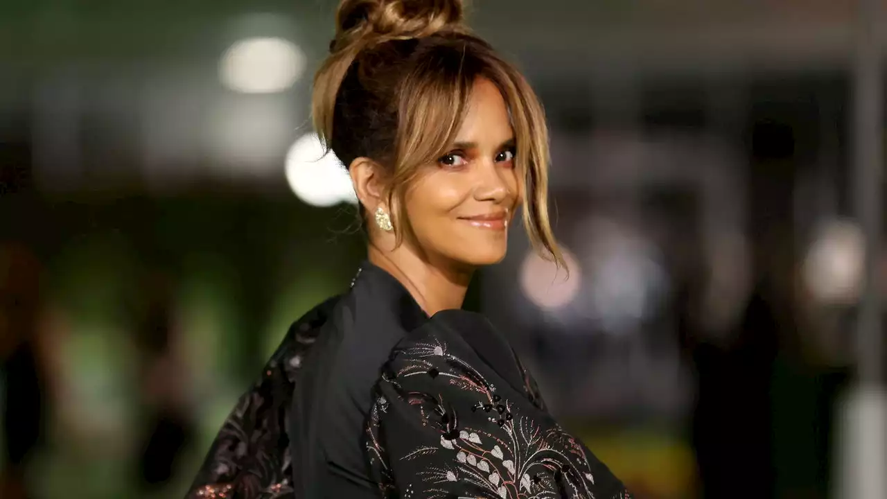 Halle Berry shines in a sequin jumpsuit with an extreme plunging neckline