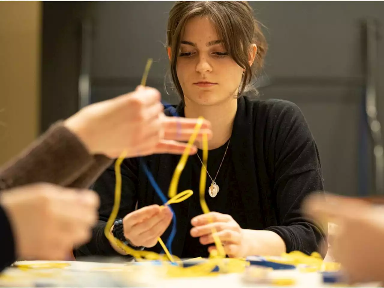 Students weave bracelets in support of Ukrainian refugees