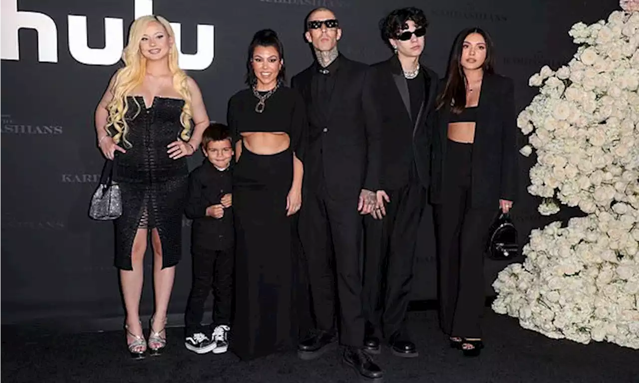 Kourtney Kardashian poses with Travis Barker and his gothic children