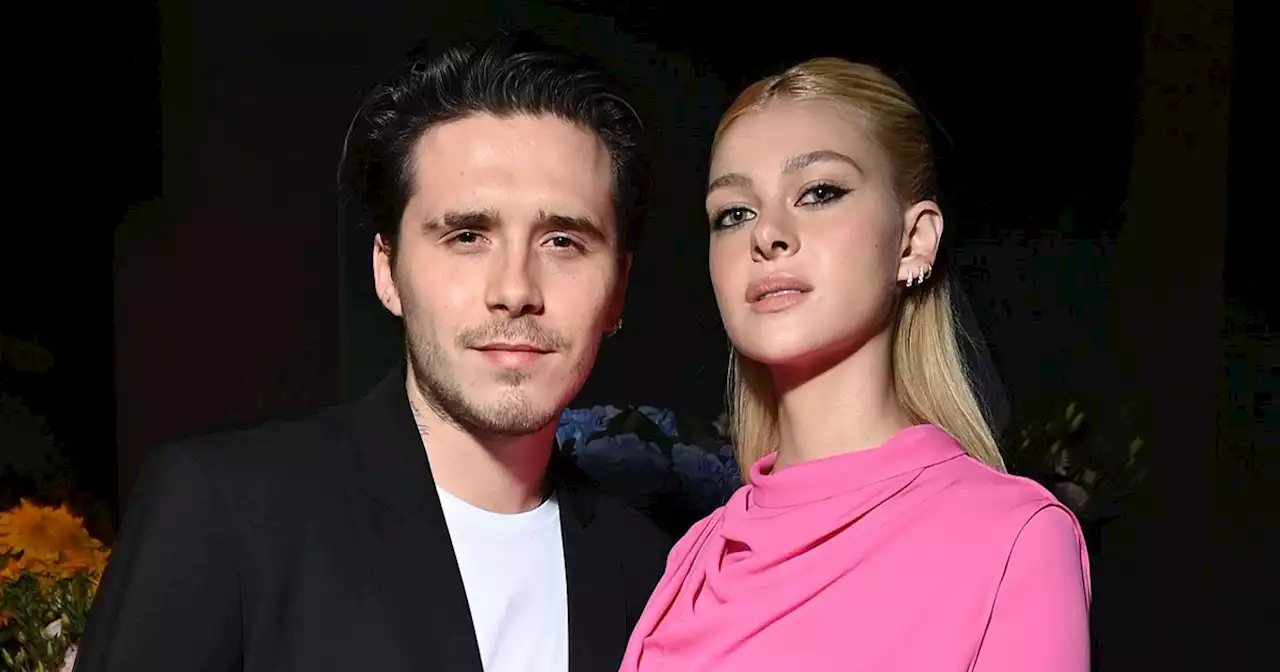 Brooklyn Beckham and Nicola Peltz exchanging vows under a chuppah at ceremony