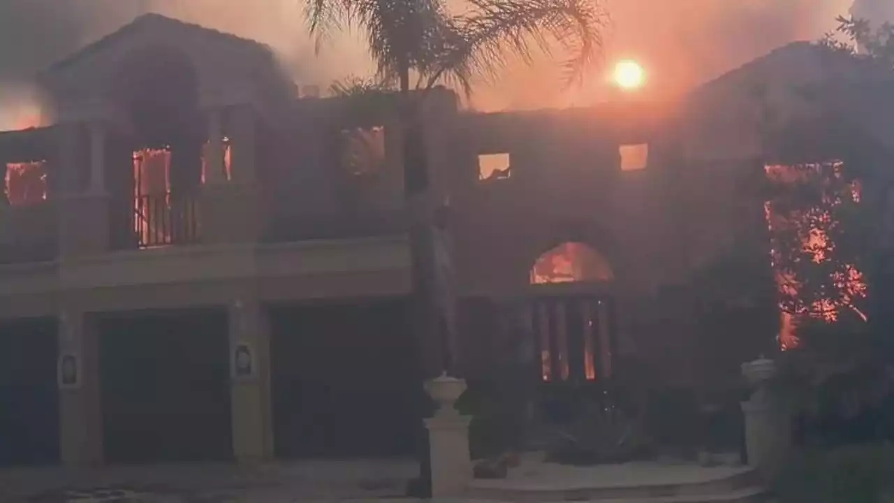 More than a dozen homes destroyed, damaged as wildfire spreads through Orange County