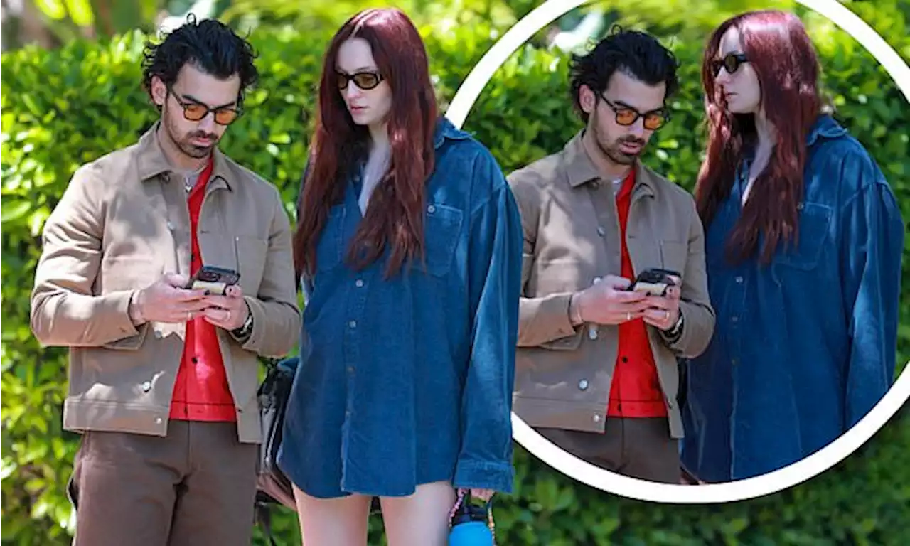 Pregnant Sophie Turner covers baby bump with oversized shirt