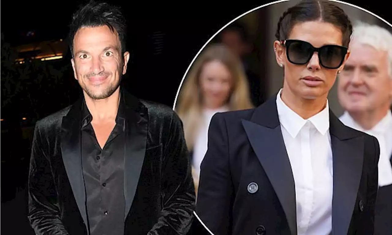 Peter Andre flashes a smile as he leaves the theatre amid manhood saga