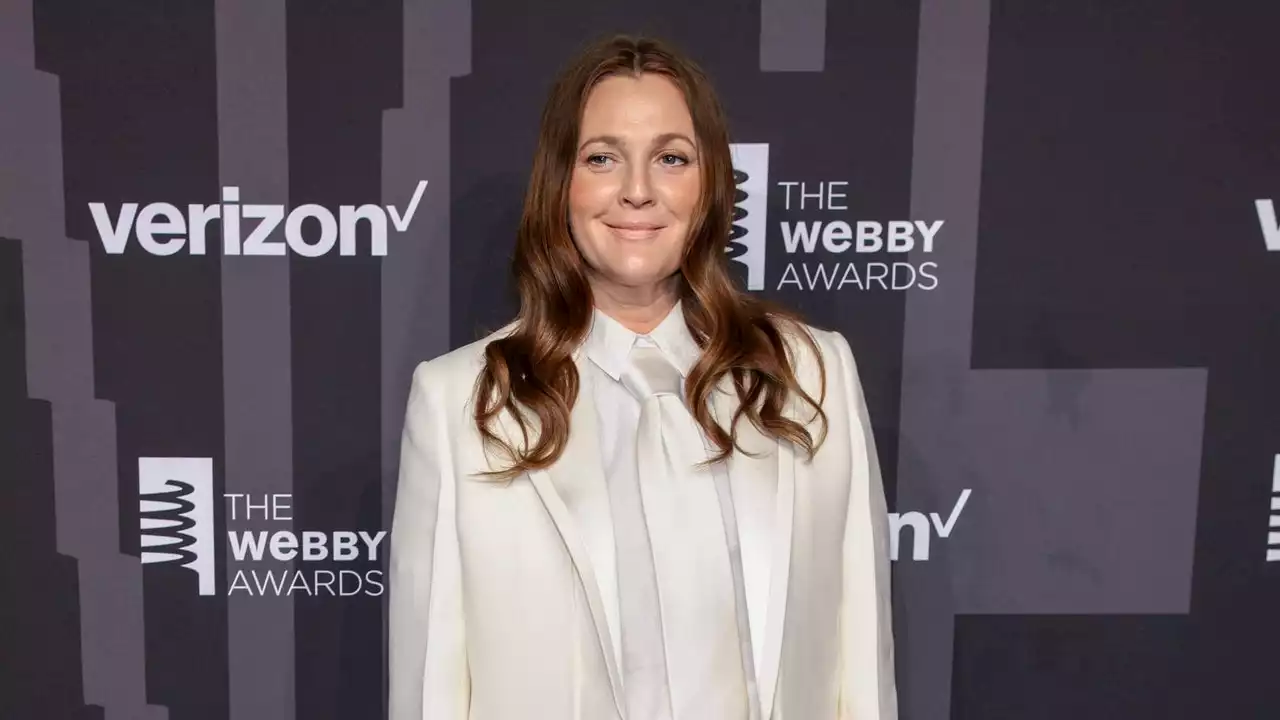 Drew Barrymore’s Crisp White Suit Is A Long Way From Her Grungy ’90s Style