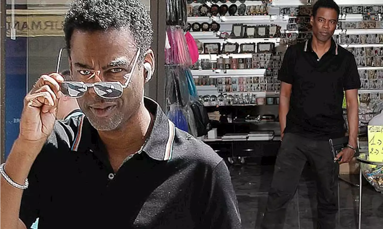 Chris Rock stops by a souvenir shop while on a stroll around Paris