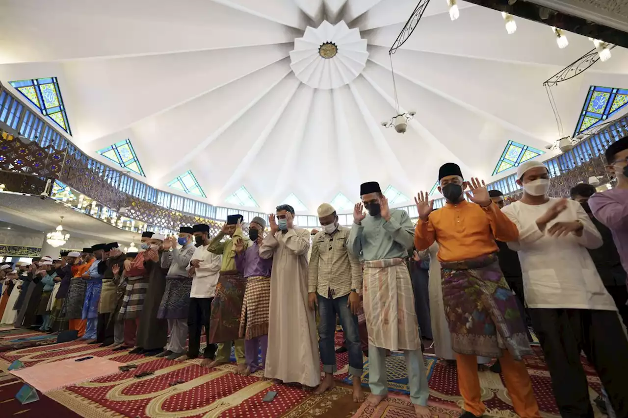 Muslims mark Eid al-Fitr holiday with joy, worry