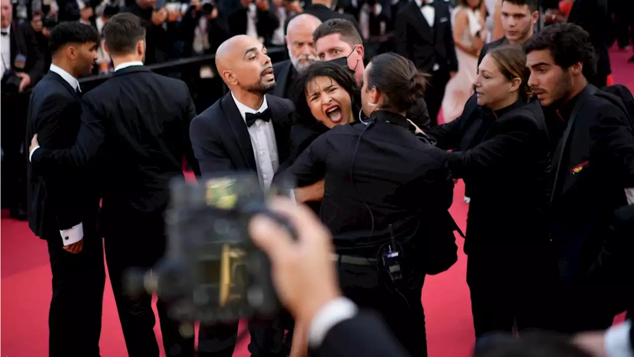 Protester crashes Cannes film festival red carpet wearing colours of the Ukrainian flag