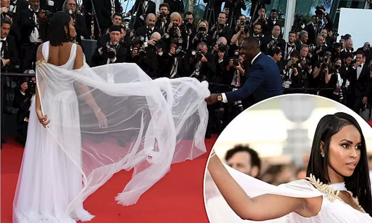 Idris Elba is ever the doting husband as he holds wife Sabrina's dress