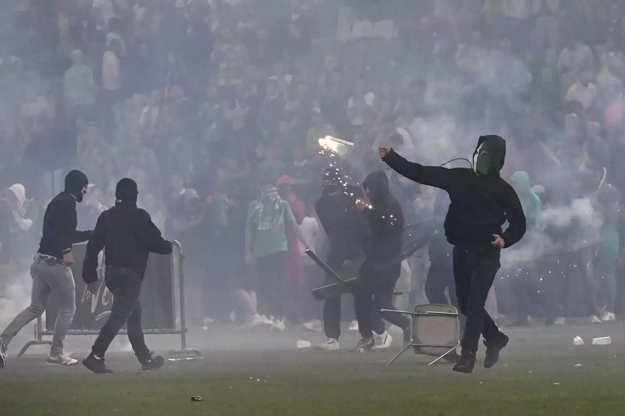 Fans storm field, throw flares at players after French team’s relegation